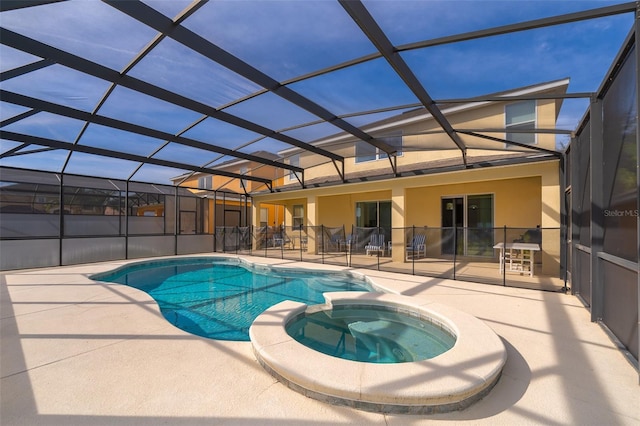 view of pool with an in ground hot tub, glass enclosure, and a patio area