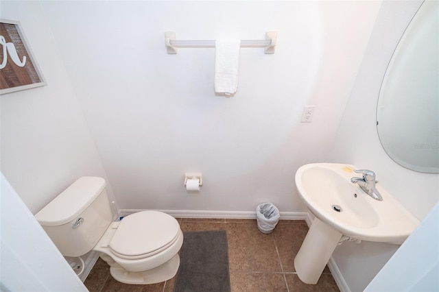 bathroom featuring toilet and tile flooring