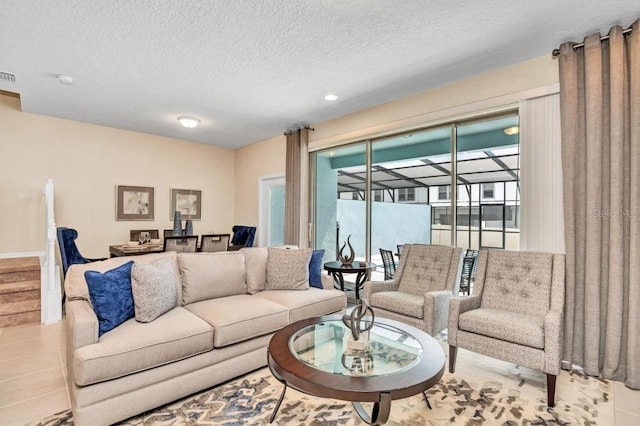 living room with light tile flooring and a textured ceiling