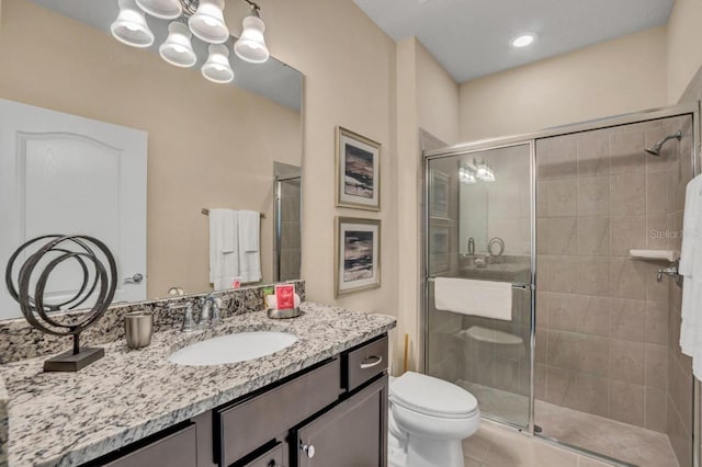 bathroom with vanity, tile floors, a shower with door, a chandelier, and toilet