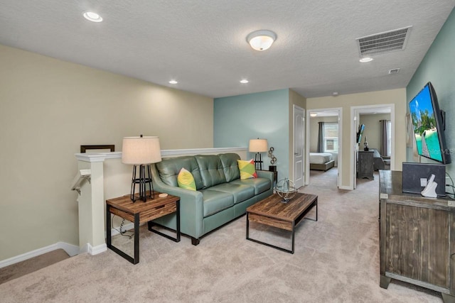 living room with light carpet and a textured ceiling