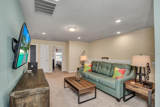 carpeted living room featuring a textured ceiling