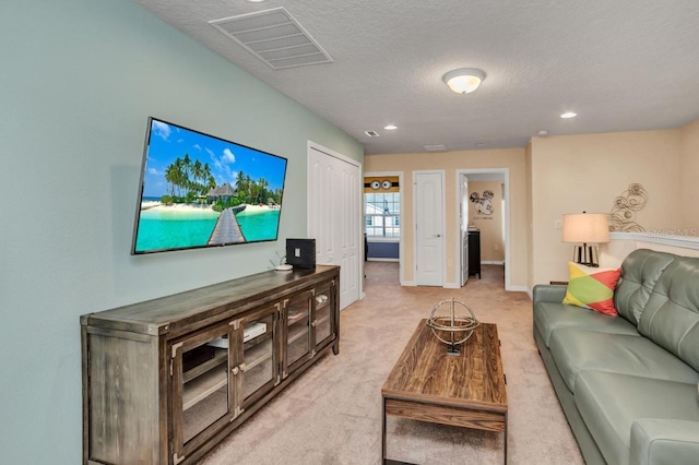 living room with light colored carpet and a textured ceiling