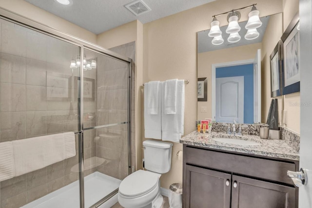 bathroom featuring walk in shower, toilet, an inviting chandelier, a textured ceiling, and vanity