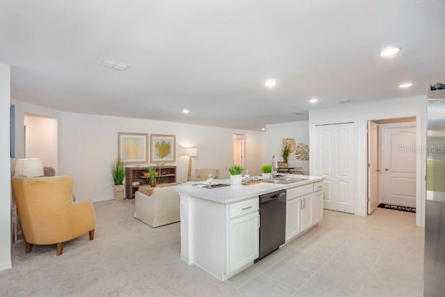 kitchen featuring light tile patterned flooring, sink, a center island with sink, black dishwasher, and white cabinets