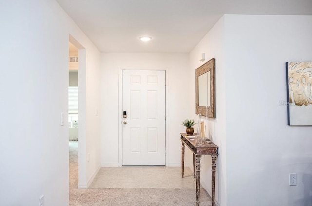 hallway with light colored carpet