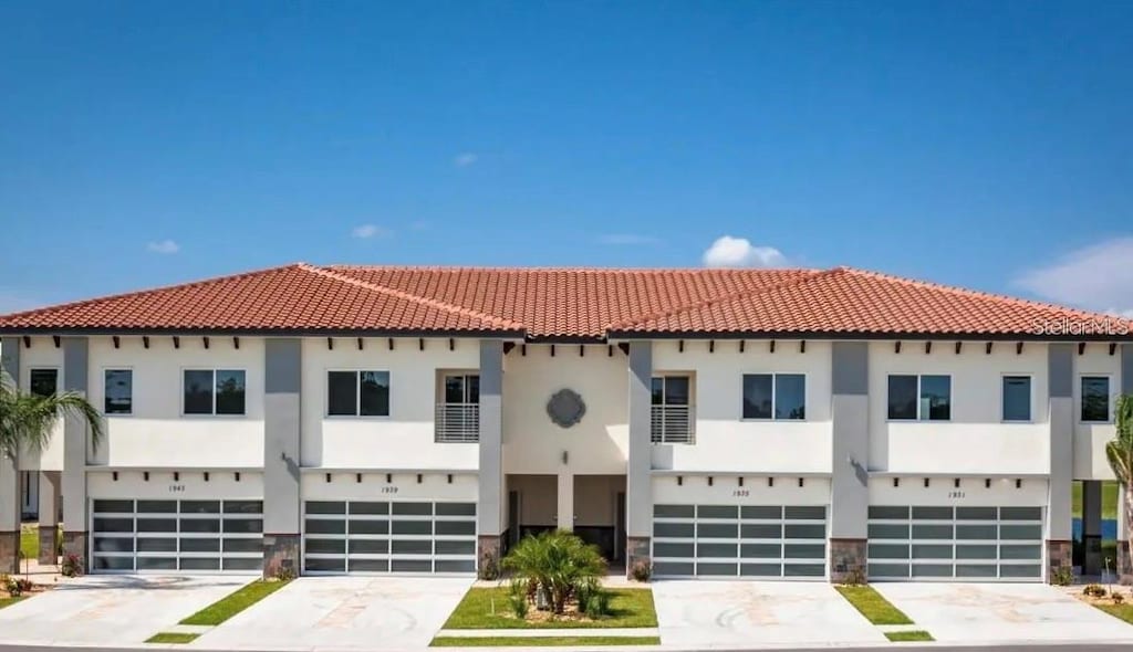 mediterranean / spanish-style home with a garage