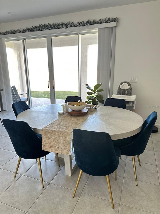 dining space with light tile floors and french doors