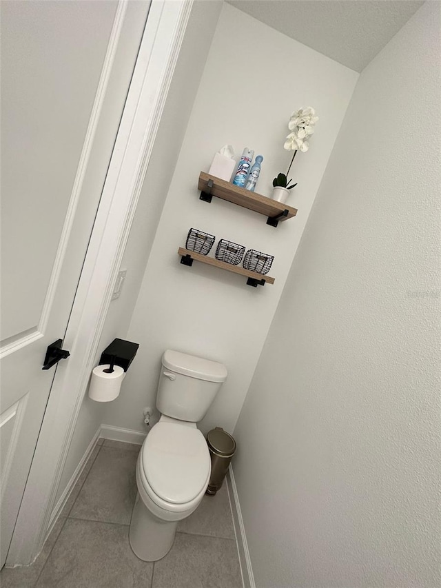 bathroom featuring toilet and tile flooring