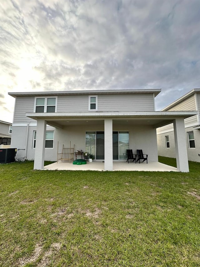 rear view of house featuring a yard and a patio area