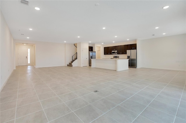 unfurnished living room featuring light tile floors