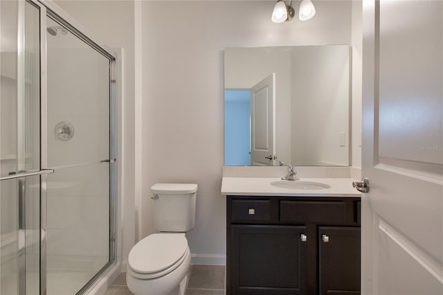 bathroom with toilet, tile floors, a shower with shower door, and vanity