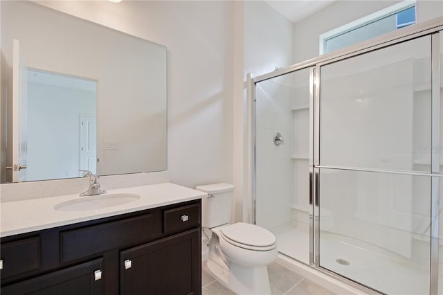 bathroom featuring oversized vanity, toilet, tile floors, and walk in shower