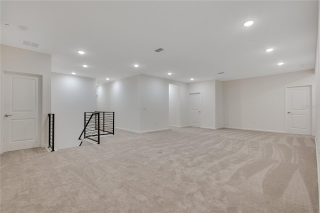 basement featuring light carpet