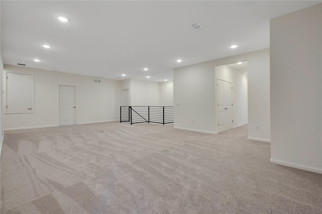 basement featuring light colored carpet