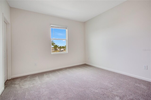 spare room with light colored carpet