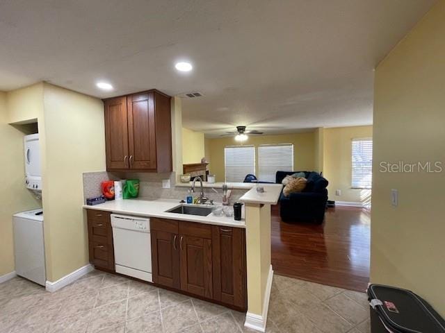 kitchen featuring dishwasher, ceiling fan, kitchen peninsula, light wood-type flooring, and sink