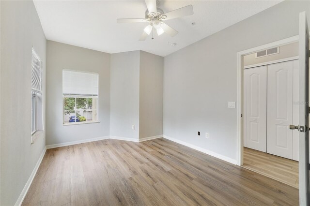 empty room featuring ceiling fan and light wood-type flooring