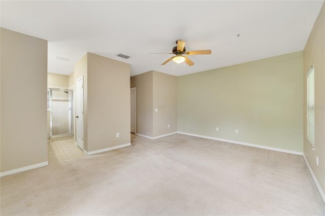 carpeted empty room featuring ceiling fan