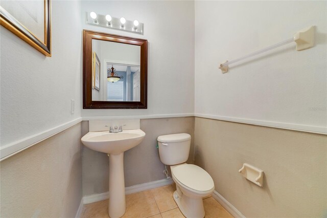 bathroom featuring toilet and tile patterned floors