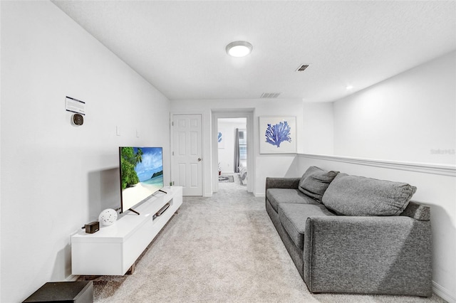 carpeted living room with a textured ceiling