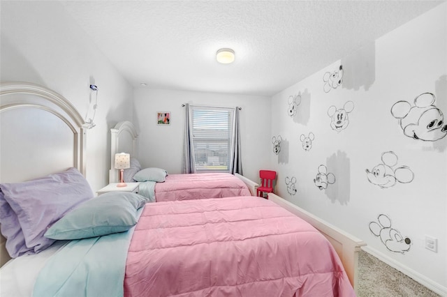 bedroom with a textured ceiling and carpet