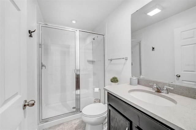 bathroom featuring vanity, tile floors, a shower with door, and toilet