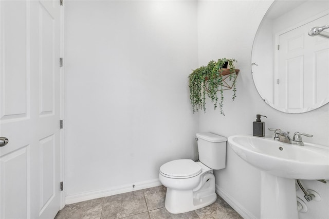 bathroom with toilet and tile floors