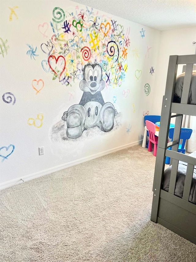 playroom with carpet flooring and a textured ceiling