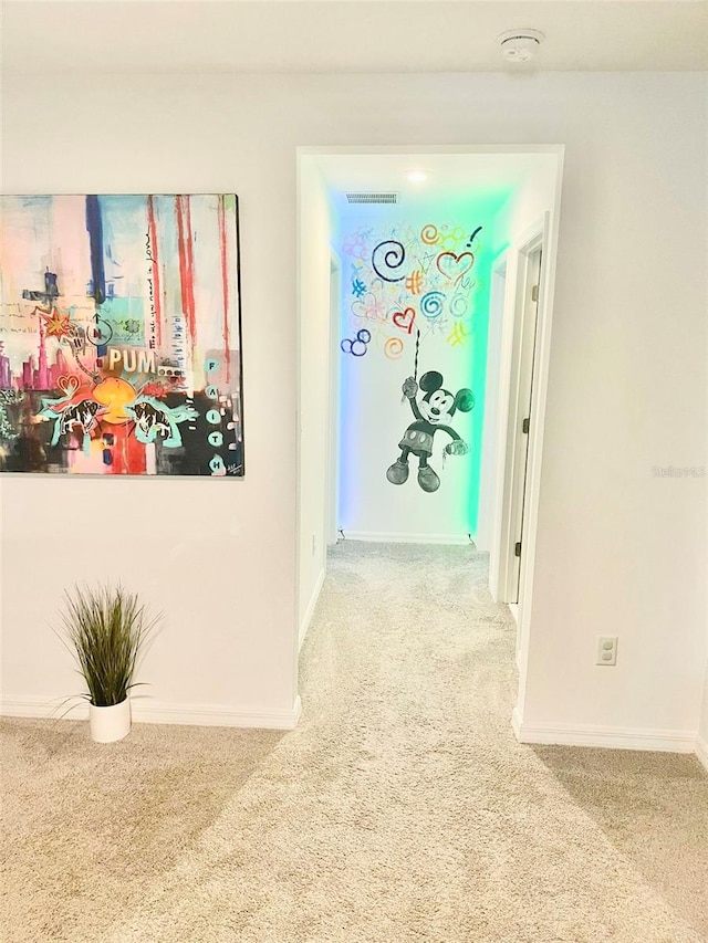 hallway featuring light colored carpet