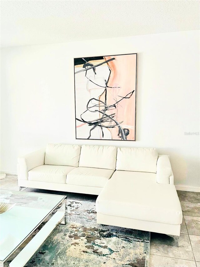 living room featuring light tile floors and a textured ceiling