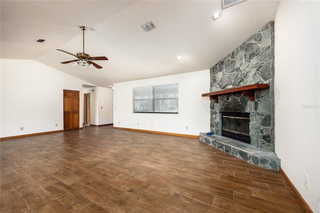 unfurnished living room featuring lofted ceiling, a stone fireplace, ceiling fan, and dark hardwood / wood-style flooring