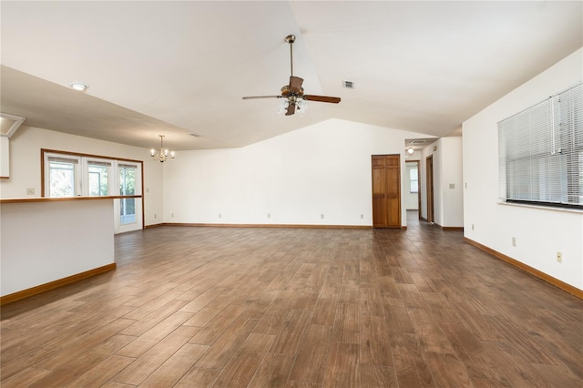 unfurnished living room featuring vaulted ceiling, dark hardwood / wood-style floors, and ceiling fan with notable chandelier