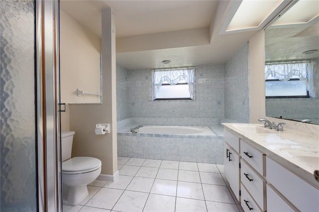 bathroom with toilet, oversized vanity, double sink, tiled bath, and tile flooring