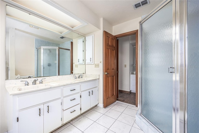 bathroom with an enclosed shower, tile floors, double sink, and large vanity