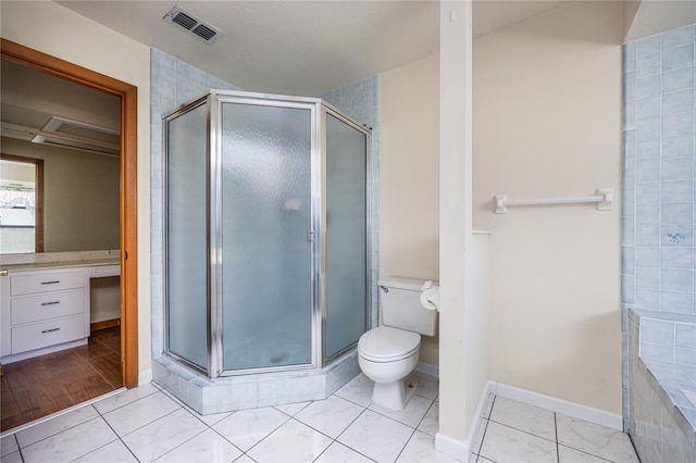 bathroom featuring vanity, hardwood / wood-style floors, a shower with shower door, and toilet