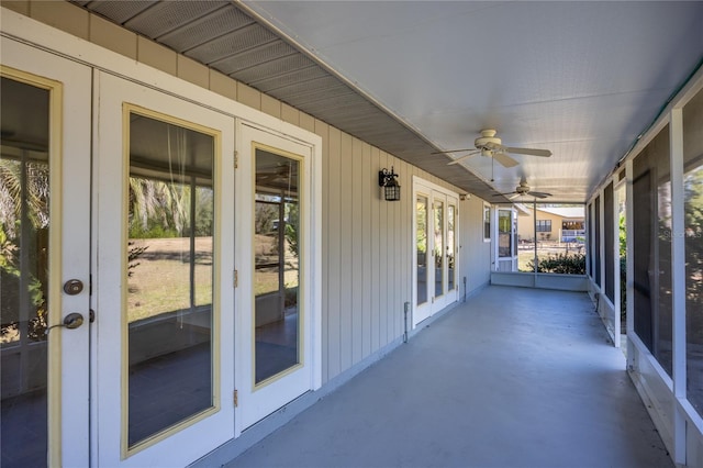 unfurnished sunroom featuring ceiling fan