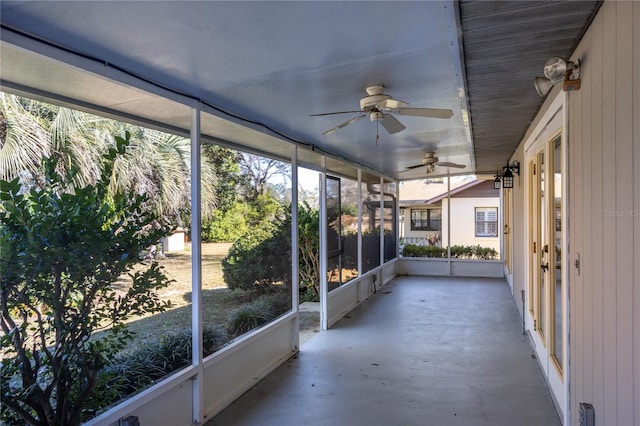 unfurnished sunroom with ceiling fan and a wealth of natural light