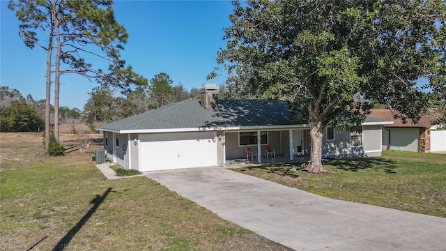 single story home featuring central air condition unit, a front lawn, and a garage