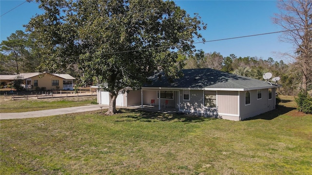 back of house with a lawn