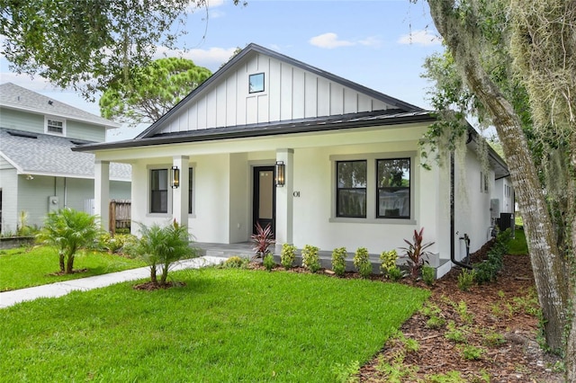 view of front of house with a porch and a front lawn