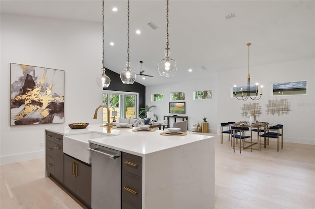 kitchen with dishwasher, sink, light hardwood / wood-style flooring, an island with sink, and pendant lighting