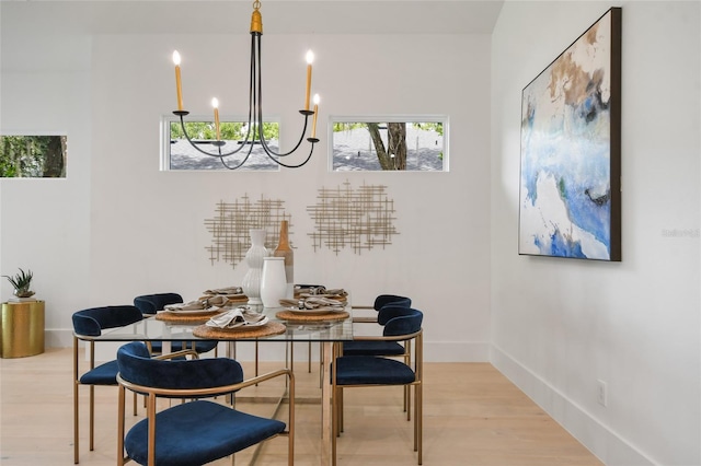 dining space with a chandelier and light hardwood / wood-style floors