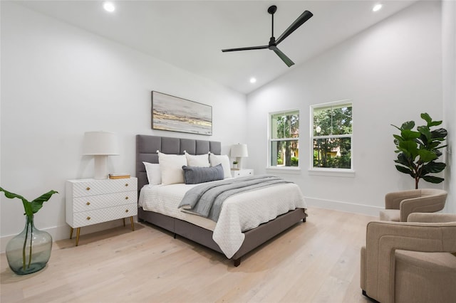 bedroom with ceiling fan, high vaulted ceiling, and light hardwood / wood-style floors