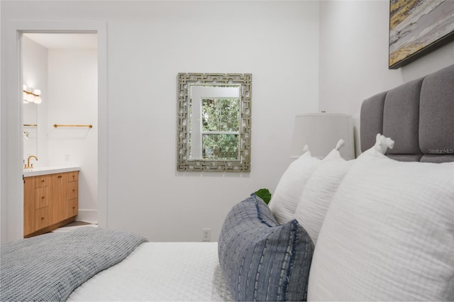 bedroom featuring ensuite bath and sink