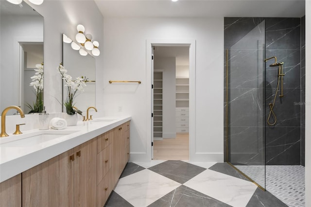 bathroom featuring tiled shower and vanity