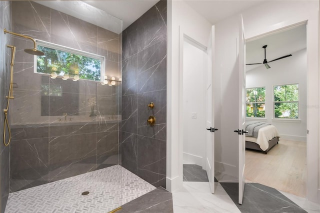 bathroom with a tile shower, plenty of natural light, and hardwood / wood-style flooring