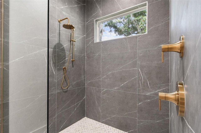 bathroom with tiled shower