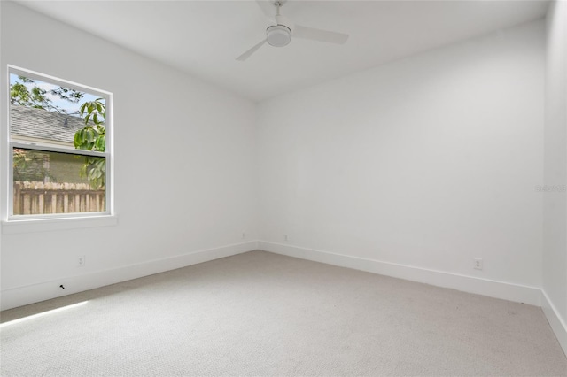 spare room with light colored carpet and ceiling fan