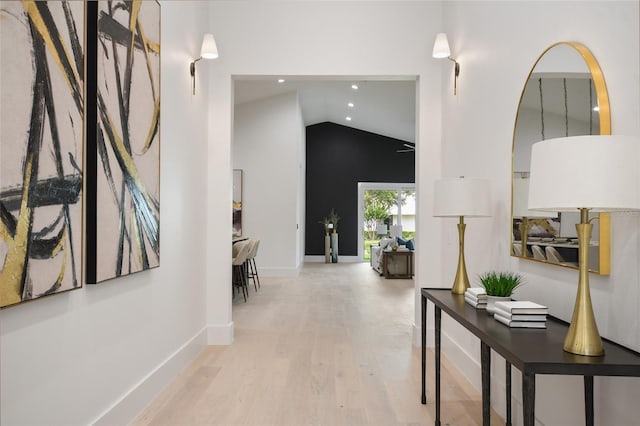 hall featuring hardwood / wood-style floors and lofted ceiling